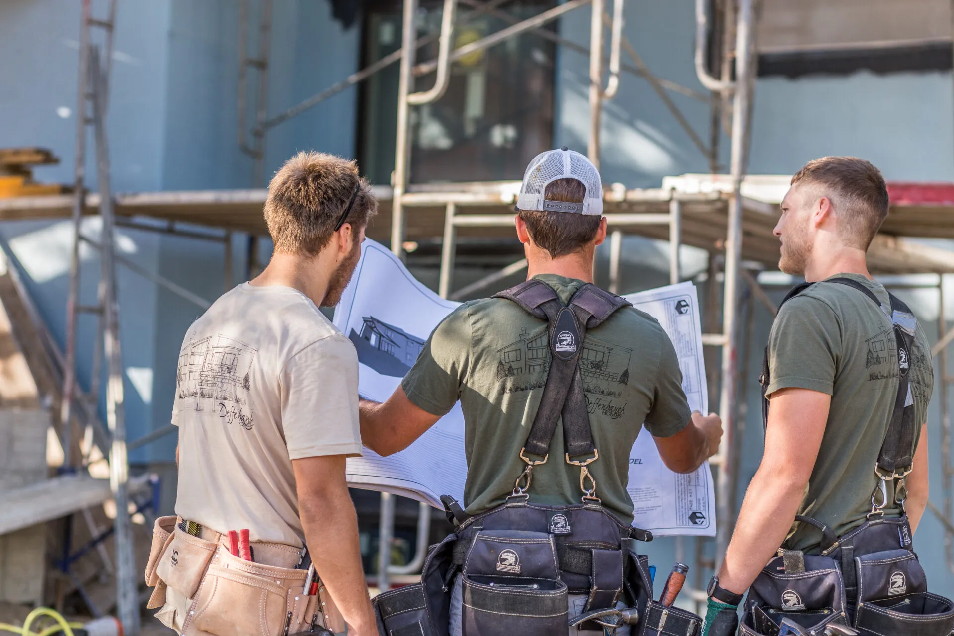 Deffenbaugh Homes team reviewing a building plan